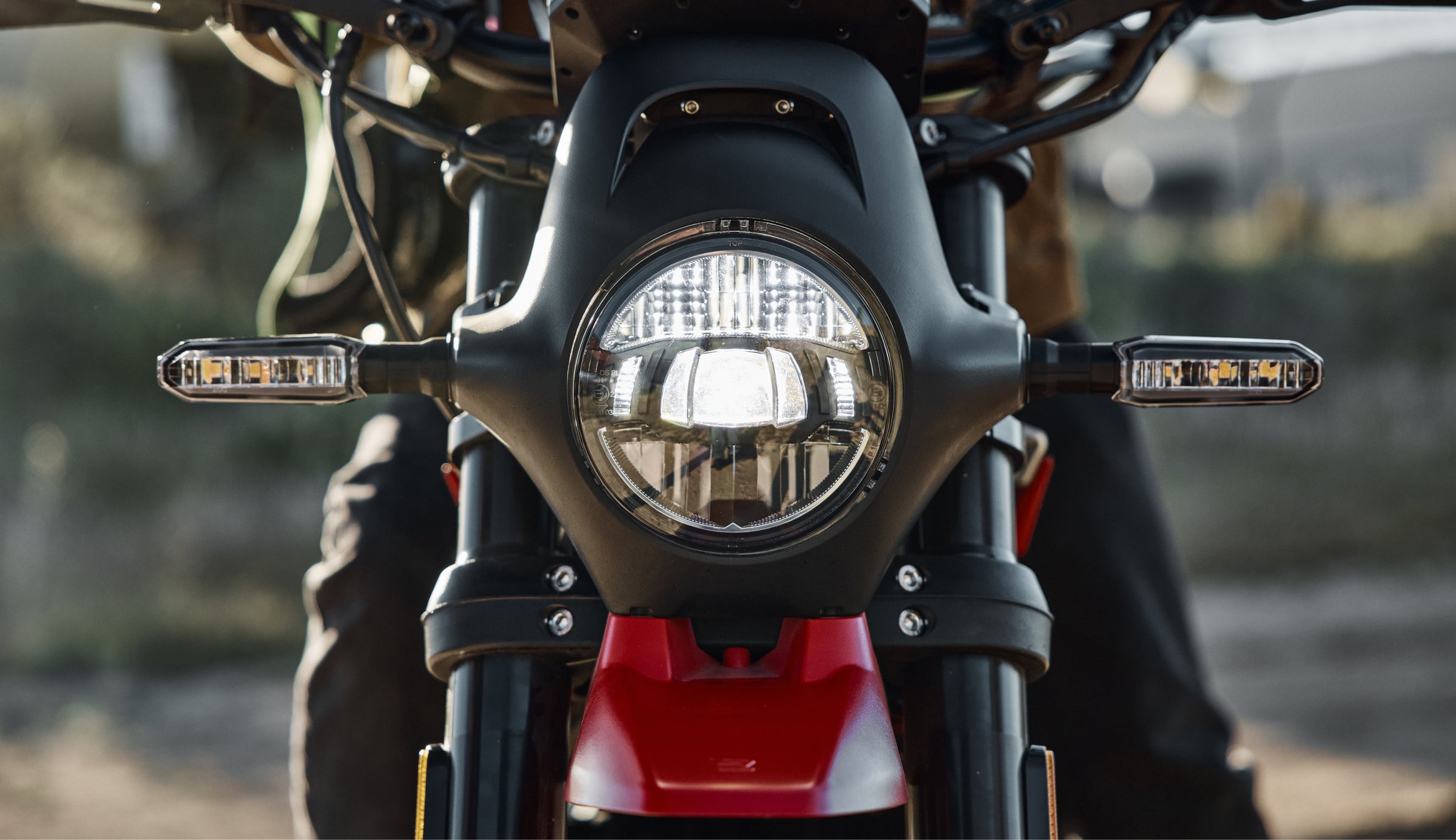Ryvid electric motorcycle riding at dusk representing pre-owned fleet opportunities